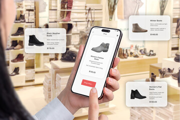 Trendy footwear in a shoe shop. Online app on a smartphone with a buy now button. Floating balloons suggesting shoe recommendations - obrazy, fototapety, plakaty