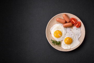 Fried chicken eggs, sausages, cherry tomatoes, chickpeas, spices, salt and herbs