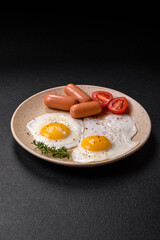 Fried chicken eggs, sausages, cherry tomatoes, chickpeas, spices, salt and herbs