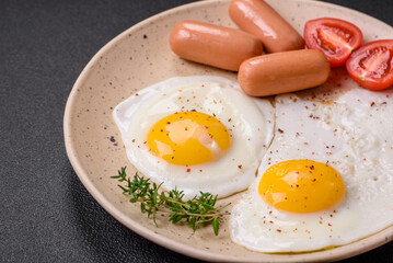 Fried chicken eggs, sausages, cherry tomatoes, chickpeas, spices, salt and herbs