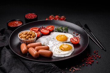 Fried chicken eggs, sausages, cherry tomatoes, chickpeas, spices, salt and herbs