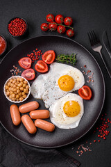 Fried chicken eggs, sausages, cherry tomatoes, chickpeas, spices, salt and herbs