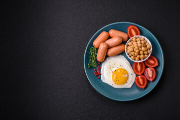 Fried chicken eggs, sausages, cherry tomatoes, chickpeas, spices, salt and herbs