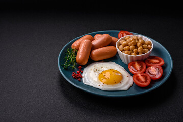 Fried chicken eggs, sausages, cherry tomatoes, chickpeas, spices, salt and herbs