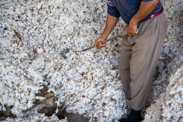 man working with a cotton in a cotton industry