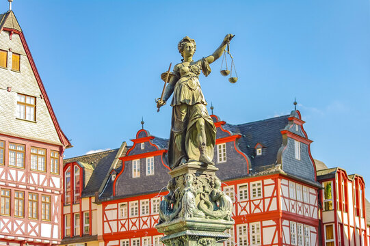 Frankfurt, Germany &ndash; Romerberg square, and fountain of justice in historical downtown with old timber houses during colorful sunset, cityscape
