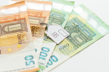 Model of house with keys on euro bills. Close up.