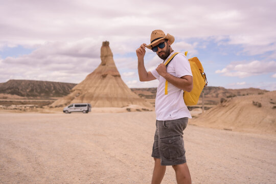 Explorer in an arid national park looking at camera