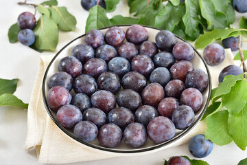 Fresh plums on plate