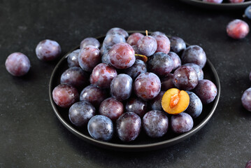 Fresh plums on plate