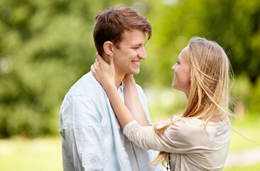 Fototapeta premium Park, happy and couple smile, eye contact and in nature, natural garden or romance date for freedom, love or bond. Partner, spring and relax man, woman or people together for care, support or embrace