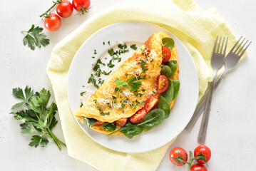 Stuffed omelette with tomatoes and spinach