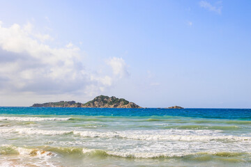 Coast of the island of Corfu near the town of Arillas under blue skies and heavy seas