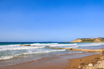 Coast of the island of Corfu near the town of Arillas under blue skies and heavy seas