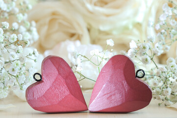 Two hearts closeup in vintage style on a background with bokeh flowers. Wedding Day, Valentine's Day concept