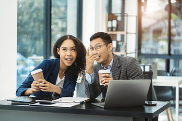 Happy creative business people holds a cup of coffee and smiles happily.