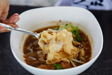 Wide rice noodles in the bowl