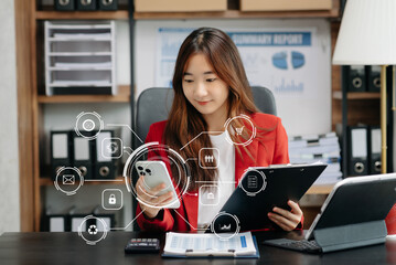  Businesswoman working with smart phone and laptop and digital tablet computer in office with...
