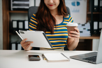 Businesswomen analyzing investment graph and discussing plan new start up project. Finance task..
