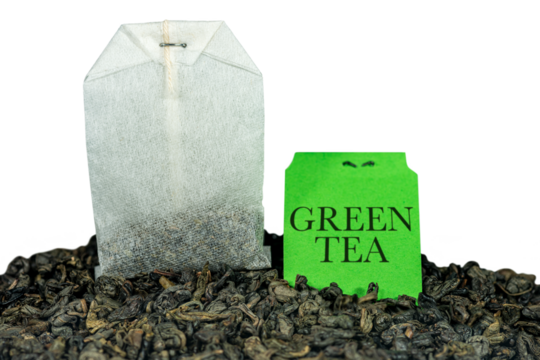Close-up of a green tea bag, Gunpowder tea, with label on many dried leaves for preparing a hot drink. Isolated on white or transparent background, png.