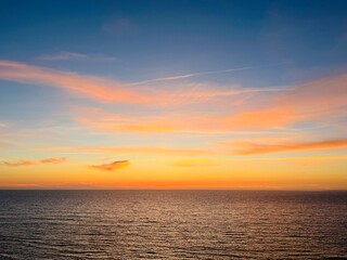 Beautiful colorful sky after the sunset at the sea coast, natural colors, sunset seascape background