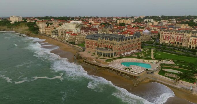 Biarritz large aerial view of the main beach and Biarritz city sunny afternoon France. View of facade of Hotel Sofitel Biarritz Le Miramar Thalassa Sea and Spa on the Miramar beach