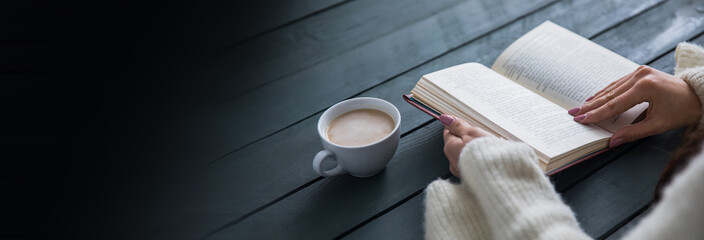 woman reading book with drinking coffee