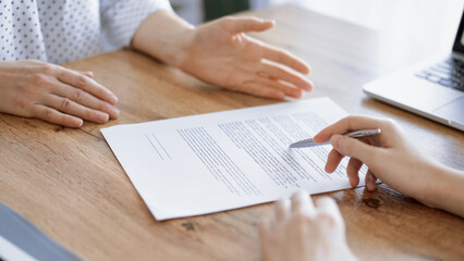 Business people discussing contract signing deal while sitting at the wooden table in office. Partners or lawyers working together at meeting. Teamwork, partnership, success concept