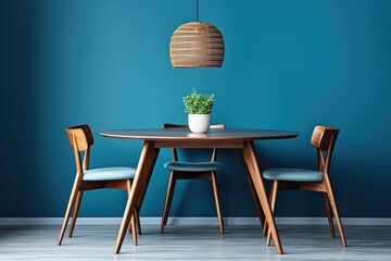Wooden dining table and chairs on a blue wall. Scandinavian home interior design for modern dining room.