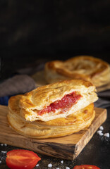 Rustico puff pastry from Lecce filled with stuffed with tomato, mozzarella and bechamel sauce