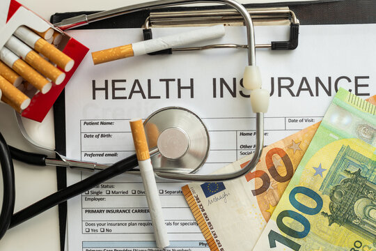A doctors stethoscope lying on an open box of cigarettes