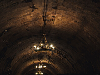 ceiling and vintage chandeliers in a dark tunnel at the old winery