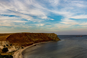 White Cirrus clouds in the blue sky on the Alexander graben. Steep cliff on the bank of the Volga...