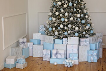 new year and Christmas tree with white and blue toys and gift boxes