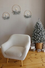 Christmas tree and armchair the snow in an apartment with gray walls