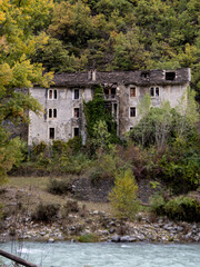 Stone house in ruins near the river. Aragonese Pyrenees. Spain. Autumn