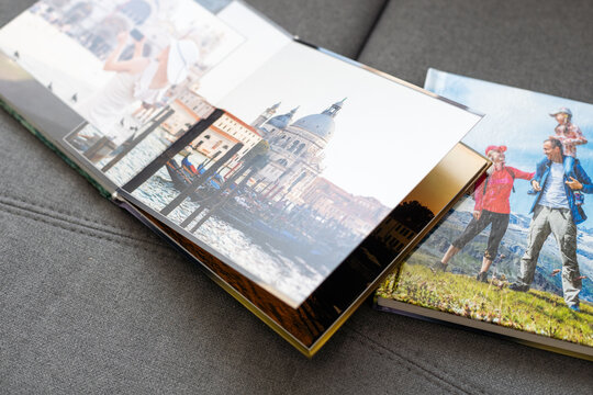a Photobook of family at home on a background. Photobook is gift. professional photographer and designer. printing of photos and journals in photo laboratory