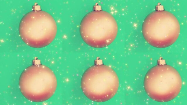 Holiday balls with the sparkles over green background