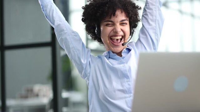 Happy excited young woman student or employee, office worker winner using laptop
