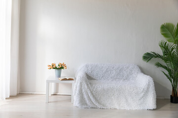 Interior of a white room with a sofa with flowers