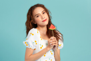 Banner of young woman holding popsicle stick with watermelon isolated on blue