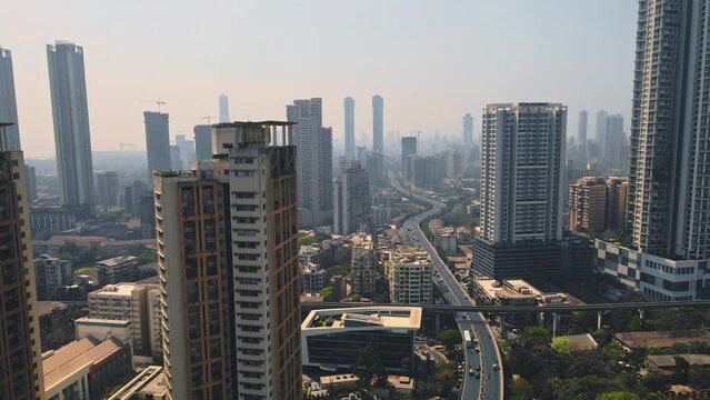 Cinematic Aerial of View Mumbai City. 4k, Drone flying above the Indian city. Modern City high-rise skyscraper buildings and busy roads in the daytime in Mumbai City.