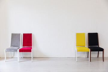 Four chairs in the interior of an white room