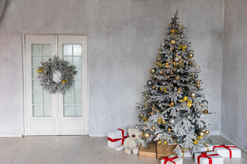 Decorated christmas tree with toys, garlands and gifts for new year