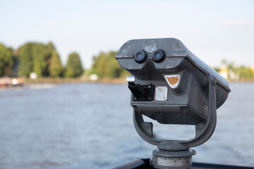 Coin operated binoculars on the edge of a river