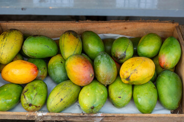 closeup of box of mangoes displayed in the fruit shop