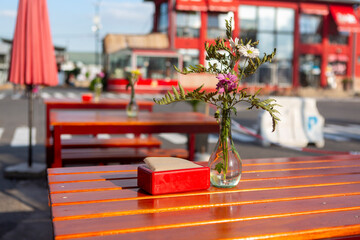 beautiful flower decorations in glass on the table on the bar terrace