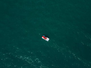 Aerial view of lifeguard boat  in beautiful  sea water in Italy baywatch italian rescue boat with oars and life preserver in ocean.  minimalism concept of adventure. Rimini, Italy.