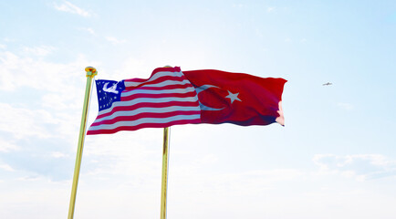 Turkey and United States Flags are waving in the spring of the blue sky.