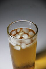 A glass of iced tea is served in a glass, ready to drink